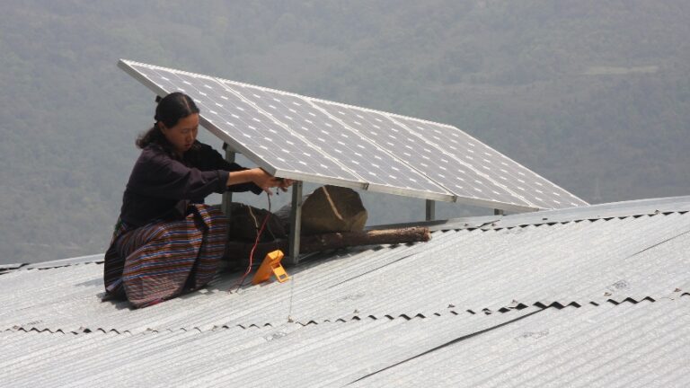 Woman working on solar panels in Bhutan.
